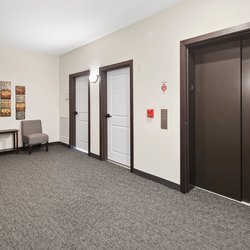 carpeted elevator at Rivertown Residential Suites located in Monticello, MN