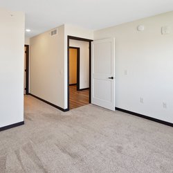 carpeted bedroom at Rivertown Residential Suites located in Monticello, MN